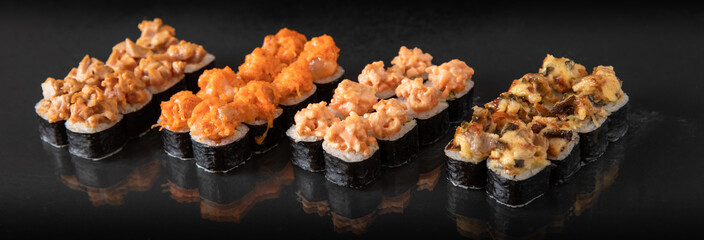 Sushi beautifully presented on a black table, culinary concept, stock photo