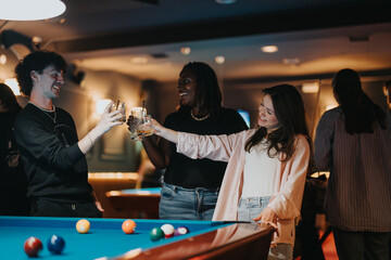 A joyful gathering of friends enjoying drinks and playing pool in a cozy bar atmosphere at night.