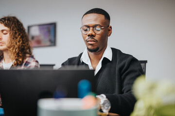 Focused young professionals in a collaborative startup environment analyzing data, brainstorming project ideas, with a vibrant multicultural team.