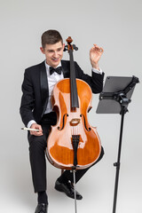 Man musician performing with cello and music note