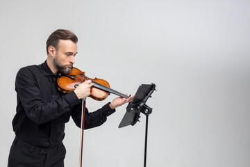 Professional musician playing violin performing concert