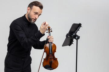 Professional musician playing violin performing concert