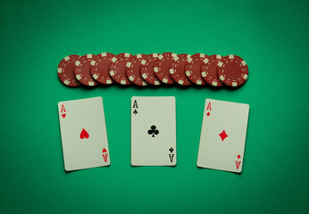 A gambling game of poker with a winning combination of three of a kind or set. Playing cards and...