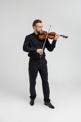 Bearded man violinist performing on concert