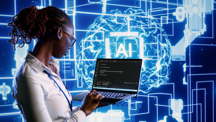 Knowledgeable IT consultant programming scripts on laptop, employing AI machine learning. Computer...