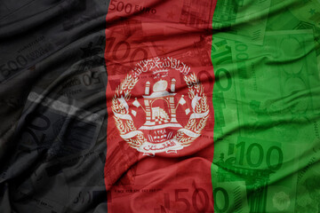 waving colorful national flag of afghanistan on a euro money banknotes background. finance concept.