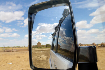 Nurbergen Kylyshev Mausoleum reflected in vehicle mirror