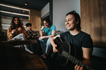 A group of friends spending quality time together, one playing guitar in a cozy setting.
