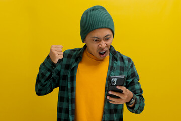 Angry Asian man, dressed in beanie hat and casual shirt, expresses frustration while shouting at...