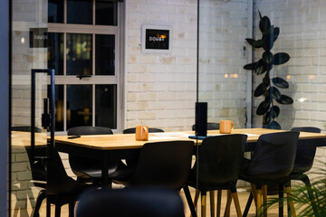 At office, working late, black chairs surrounding wooden table