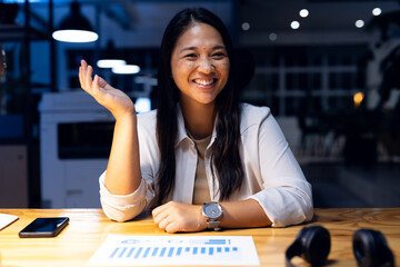 At office, biracial businesswoman laughing during video call