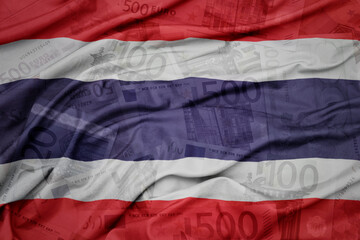 waving colorful national flag of thailand on a euro money banknotes background. finance concept.