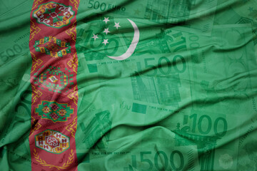 waving colorful national flag of turkmenistan on a euro money banknotes background. finance concept.