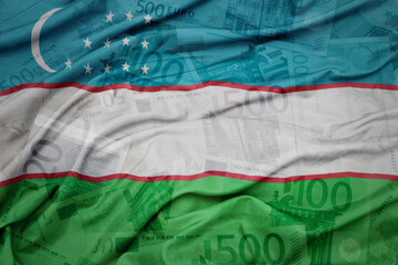 waving colorful national flag of uzbekistan on a euro money banknotes background. finance concept.
