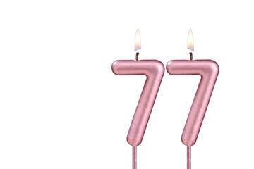 Lit birthday candle - Candle number 77 on white background