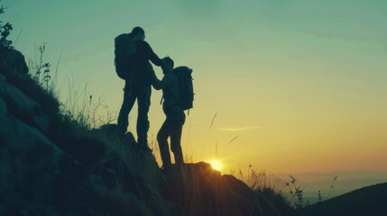 Silhouette of Two Man Holding Hands to Mountain with Climbing sport for Helping hand friendship Concept