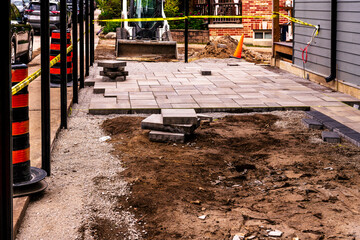 home construction: patio and walkway paving stone instalation in progress at a new house build in...