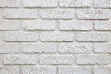 A white brick wall with white brick pattern