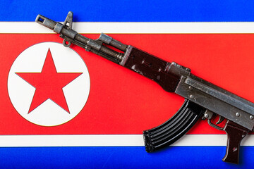 A gun is placed on the flag of North Korea