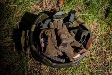 Fototapeta premium Military equipment, assault helmet, tactical gloves Individual protection of the military, tactical equipment.