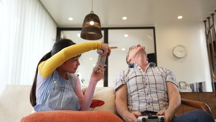 Grandfather and granddaughter together play console game, entertainment media. Old senior use...