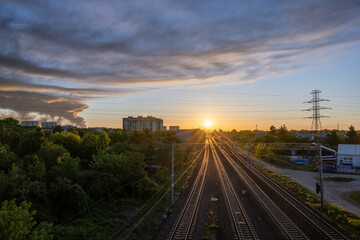 Obraz premium Dawn and Distress: Sunrise over the Tracks