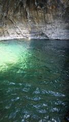 water reflection near rocks