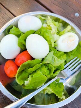 Fresh salad with hard-boiled egg and tomato cherry