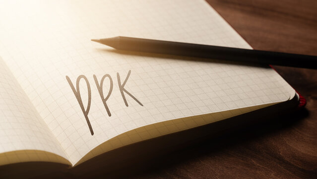  A handwritten inscription "PPK" on a grille of an open notebook on a wooden countertop, next to a black pencil, lighting of light. (selective focus)