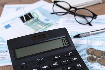 Tax accounting. Calculator, documents, money, glasses and pen on table, closeup