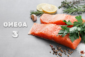 Omega 3. Fresh cut salmon, herbs and spices on grey table, closeup