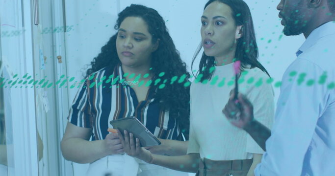 Image of graphs over diverse coworkers discussing strategy on whiteboard in office