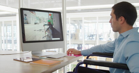 Image of biracial colleague wearing blue shirt, focusing on computer screen - Powered by Adobe