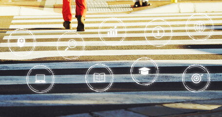 Image of multiple digital icons against low section of man crossing the street