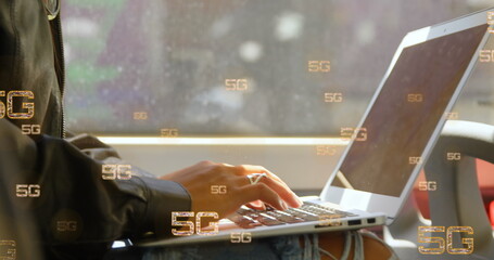 Image of multiple 5g text banners against mid section of a woman using laptop in a bus - Powered by Adobe