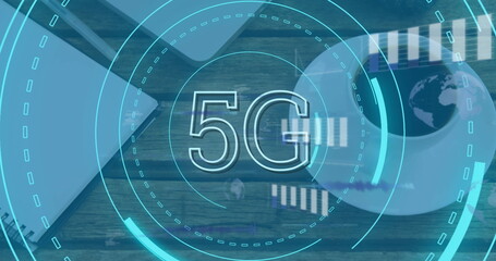 Image of 5g text and data processing against close up of a laptop and coffee cup on wooden table