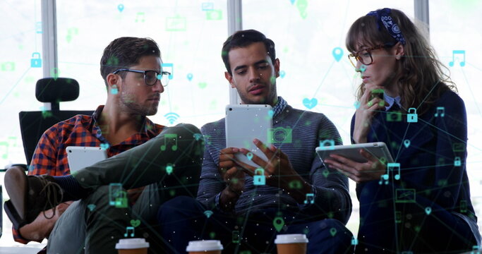 Image of network of digital icons against diverse group of colleagues discussing at office