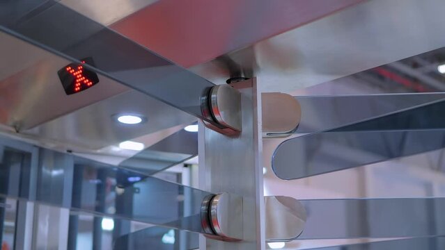 Modern full height rotating barrier, turnstile with electronic control system - entrance point at stadium, airport or office: close up view. Safety, access and security equipment concept