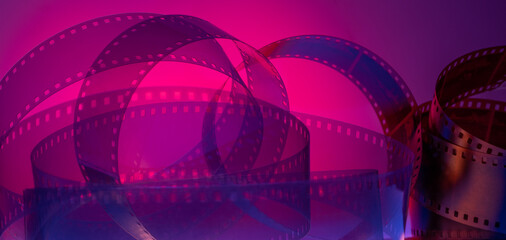 multi-colored background with real movie tape. cinema background for film production, film...