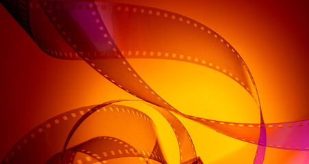 multi-colored background with real movie tape. cinema background for film production, film...