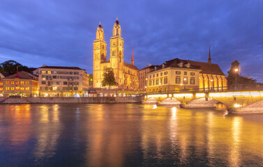 Famous Grossmunster churche and river Limmat at night in Old Town of Zurich, Switzerland