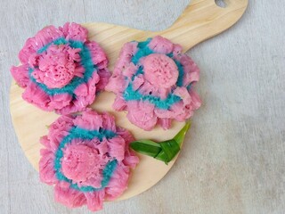 Kue carabikang or carabikang cake placed on wooden cutting board. Sweet cake from Indonesia made from rice flour and coconut milk.