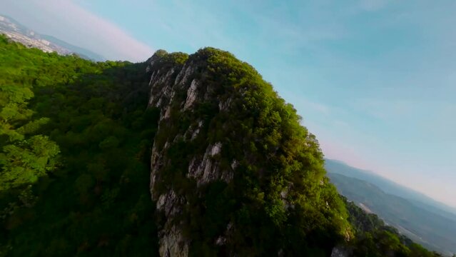 An aerial FPV view peak of rocky hills Bukit tabur during morning.