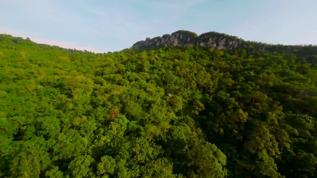 An aerial FPV view peak of rocky hills Bukit tabur during morning.