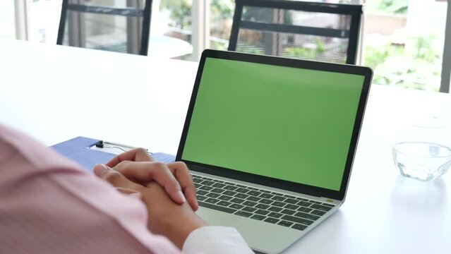 Closeup businessman hands working use laptop finance business document reading report paperwork spreadsheet at office desk. Man hands type keyboard write on office note check financial graph chart