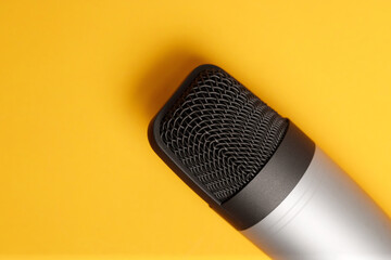 Studio microphone isolated on yellow background