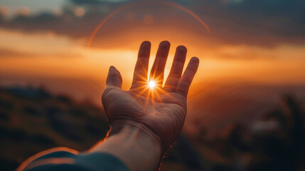 Hand of a man against the background of a beautiful sunset. The concept of freedom and hope.