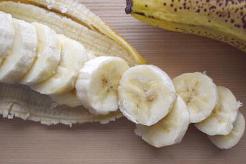 Sliced banana. Ripped banana on chopping board. 