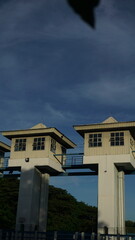 Buildings on top of a water storage dam, vertical photo of dam