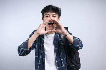 Young Student Man Shouting Out Loud With Hands Over Mouth Isolated On White Background